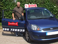 Castle Driving School instructor standing by his vehicle
